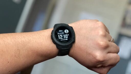 person wearing black garmin digital watch