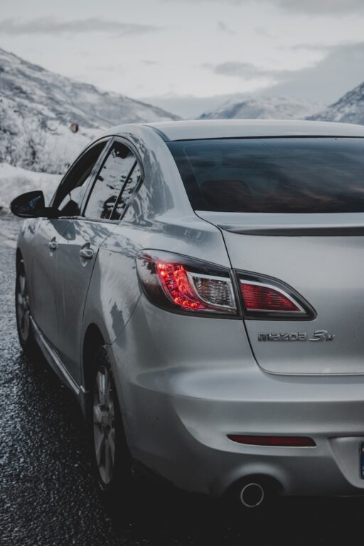 silver mazda car on road