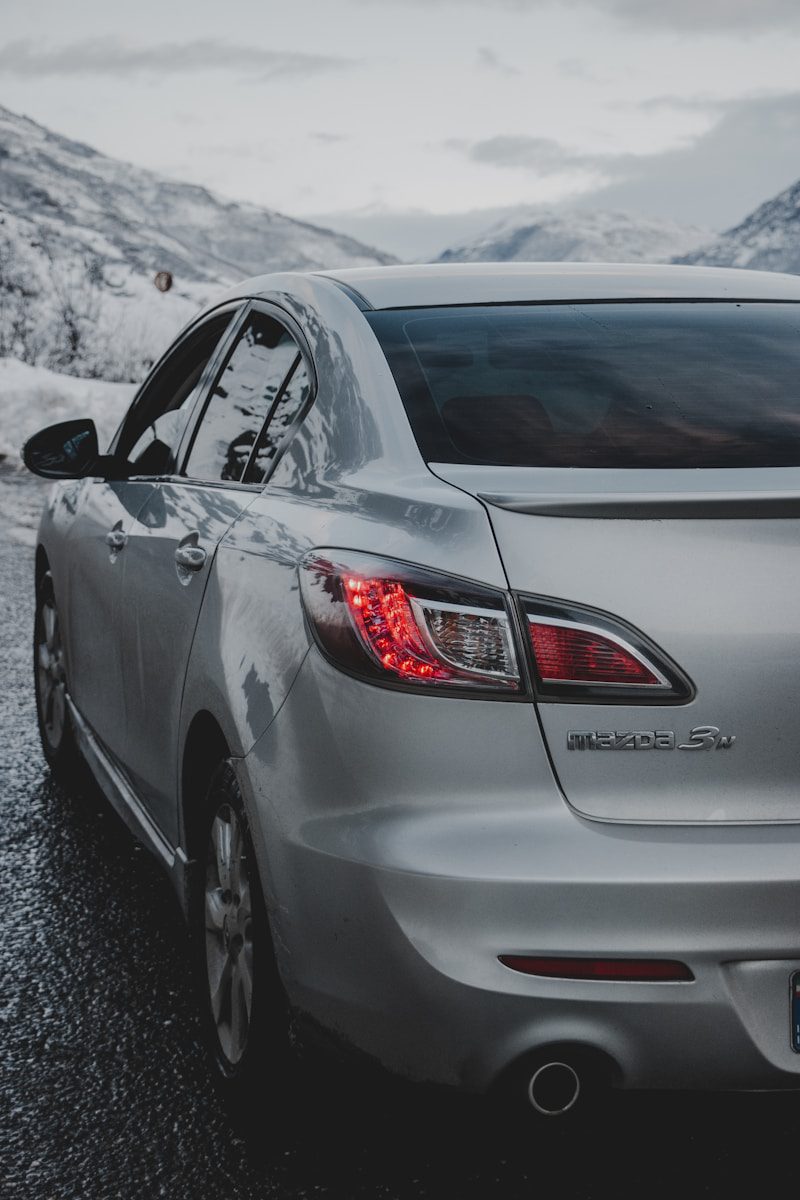 silver mazda car on road