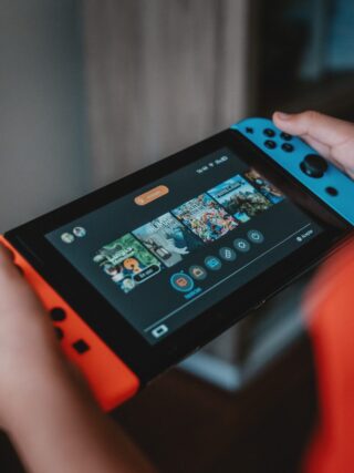person holding nintendo switch