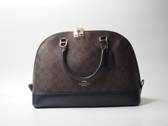a coach handbag sitting on top of a white table