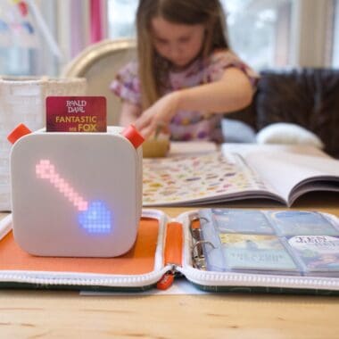 girl in white long sleeve shirt using yoto devices